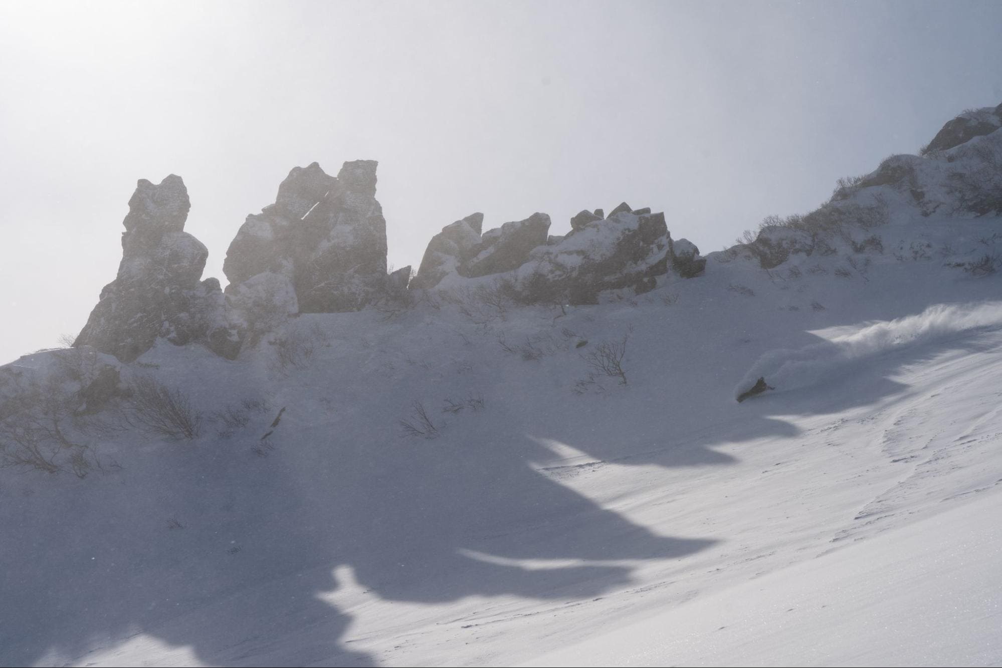 skier making a turn in very deep snow in Furano Dake